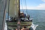 View from the bowsprit net towards the bow of the Gulden Belofte under sail
