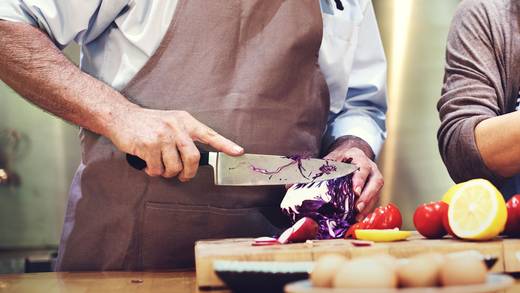 Preparing a meal together by chopping vegetables