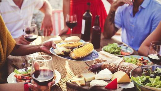 A group sharing a meal around a table laden with food