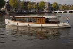 Saloon boat Emma on a city canal, viewed from the side