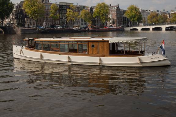 Saloon boat Emma on a city canal, viewed from the side