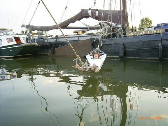 Guest in a hammock above the water beside the Vrouwe Jitske