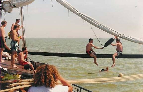 Guests having a pillow fight on the boom of the Vrouwe Jitske