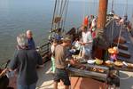 Guests having a barbecue on the deck of the Albatros while resting on the tidal flats