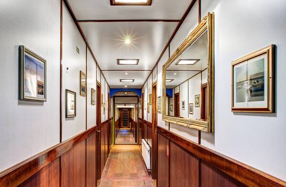 Wood-panelled corridor along the cabins of the Mare fan Fryslân