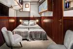 Cabin with a double bed and armchairs on the Mare fan Fryslân