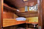 Wood-panelled cabin with bunk beds and a skylight on the Orion