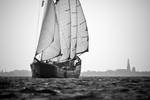 Mare fan Fryslân under sail with a port town in the background