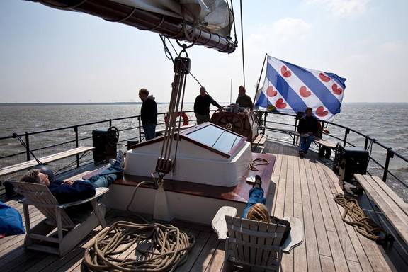 Guests relaxing on the aft deck of the Mare fan Fryslân