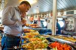Guests serving themselves at the buffet on the Eendracht; photo: Rienk Boode