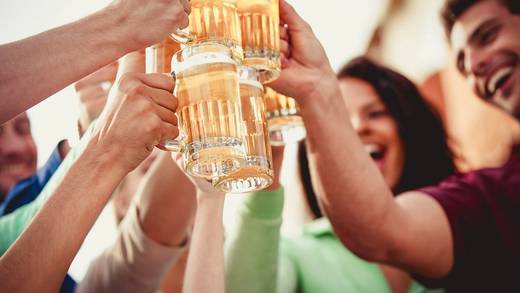 Group raising beer glasses in a toast